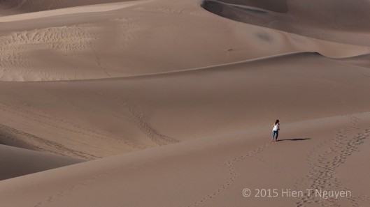 Girl running barefoot at Great Sand Dunes.